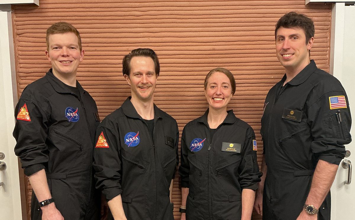Members of NASA’s CHAPEA (Crew Health and Performance Exploration Analog) Mission 2 crew stands in their workspace after spending a year in their isolated and confined habitat at NASA’s Johnson Space Center in Houston. (from left: James Spicer, Matthew Montgomery, Ellen Ellis, and Ross Elder). Credi