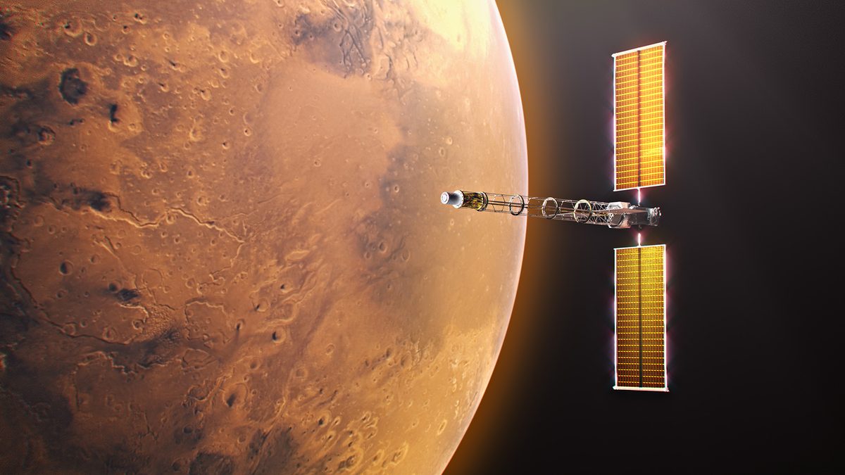 Digital illustration of the Space Reactor-1 (SR-1) Freedom spacecraft in orbit near Mars. The planet's red terrain fills the left half of the frame. On the right, the spacecraft is oriented horizontally, showcasing its central Power and Propulsion Element bus flanked by two tall, illuminated golden