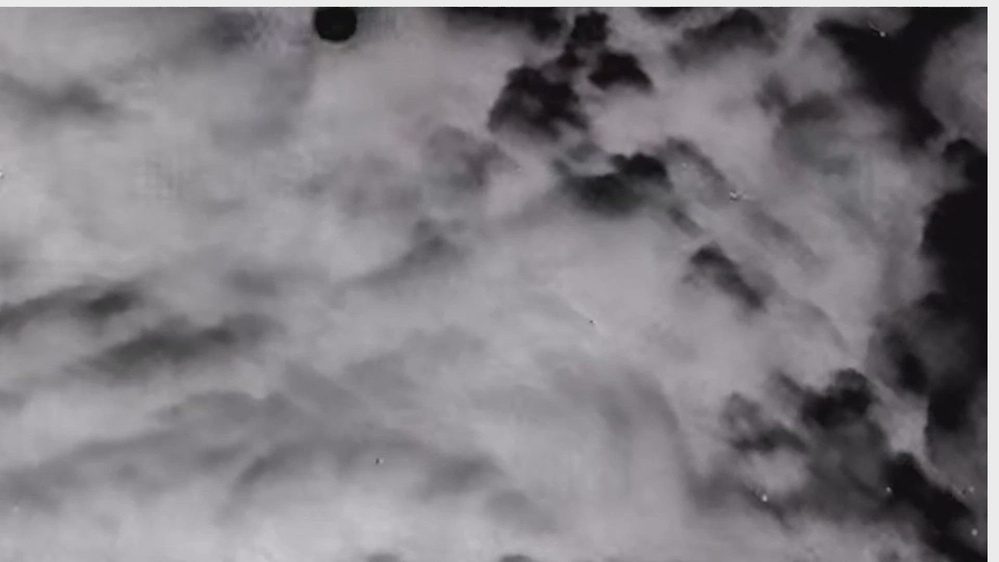 Still frame from the video DOW-UAP-PR055, "Spherical UAP over AFG in and out of clouds 23 Nov 2020"