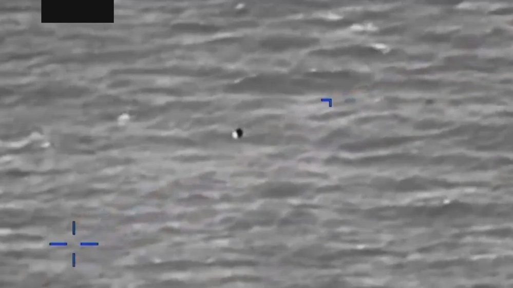 Still frame from the video DOW-UAP-PR056, "Spherical UAP pulsing over water [CALLSIGN]"